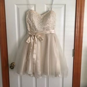 Masquerade above the knee champagne dress.